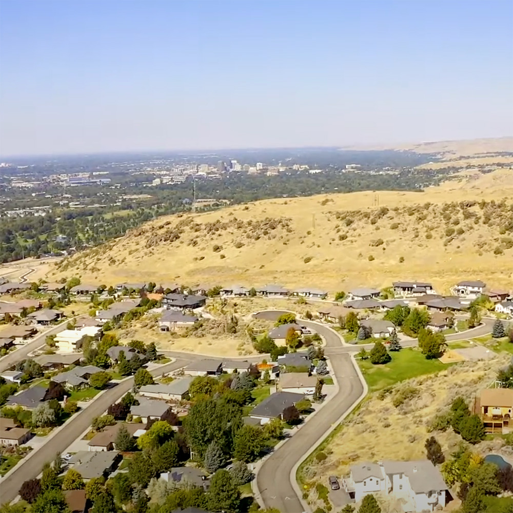 Aerial view of Bogus Basin neighborhood against city view of Boise Idaho.